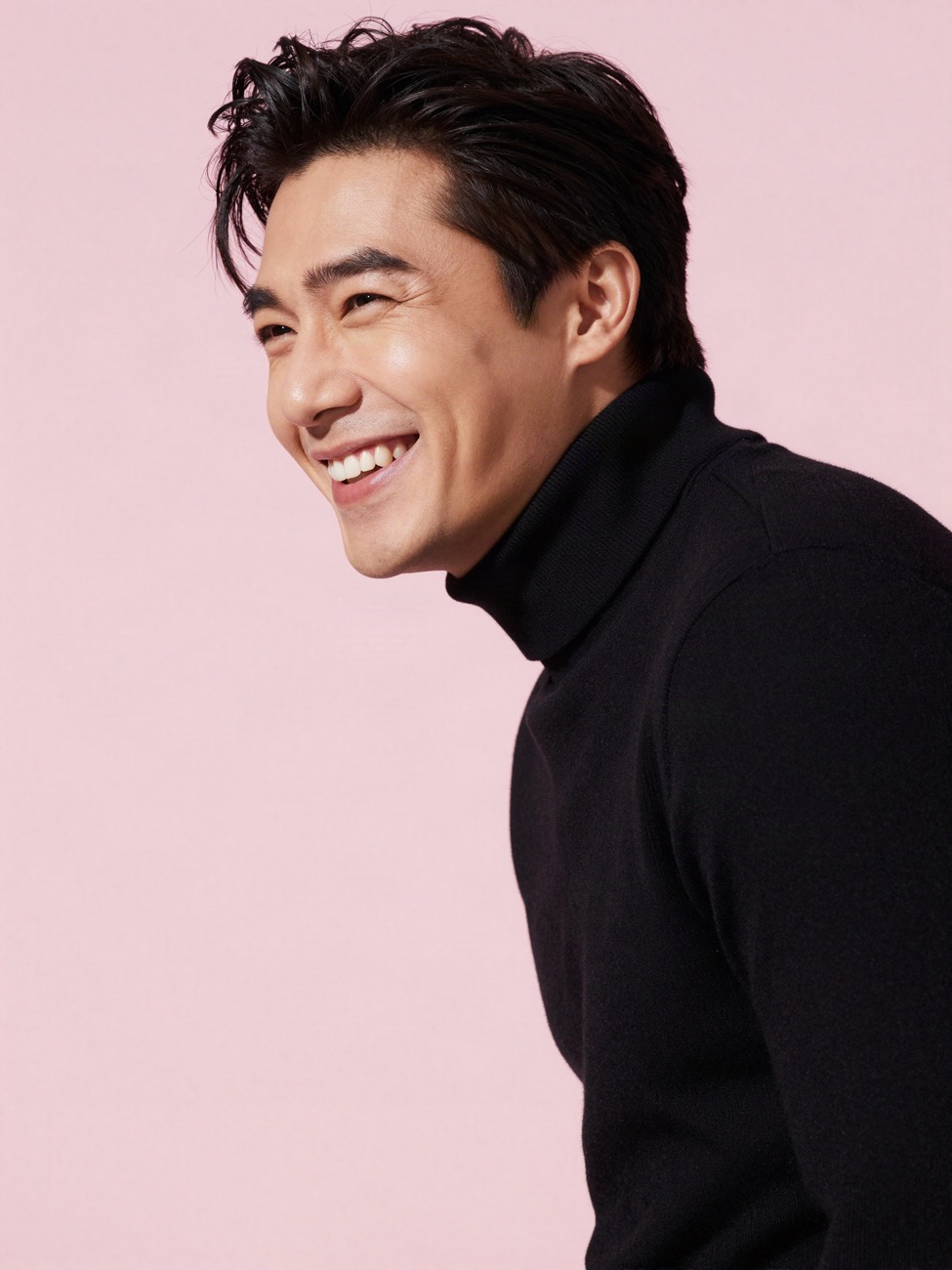 A man laughing with a bright smile
