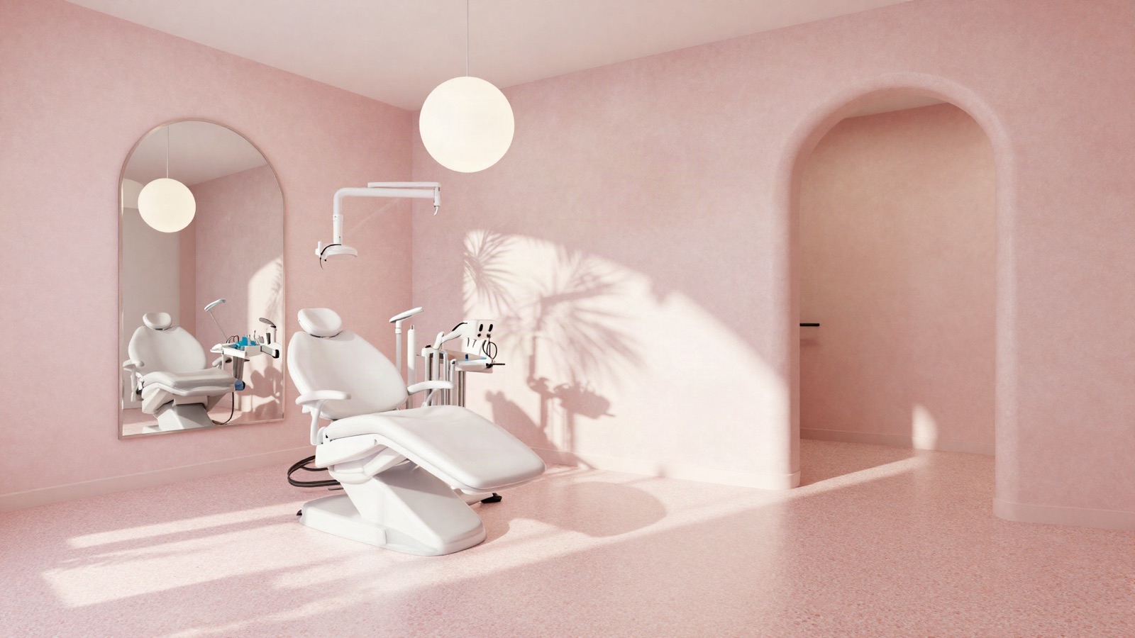 Pink terrazzo treatment room with an arched mirror and palm shadows